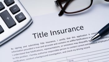Title Insurance Form Near Calculator And Glasses