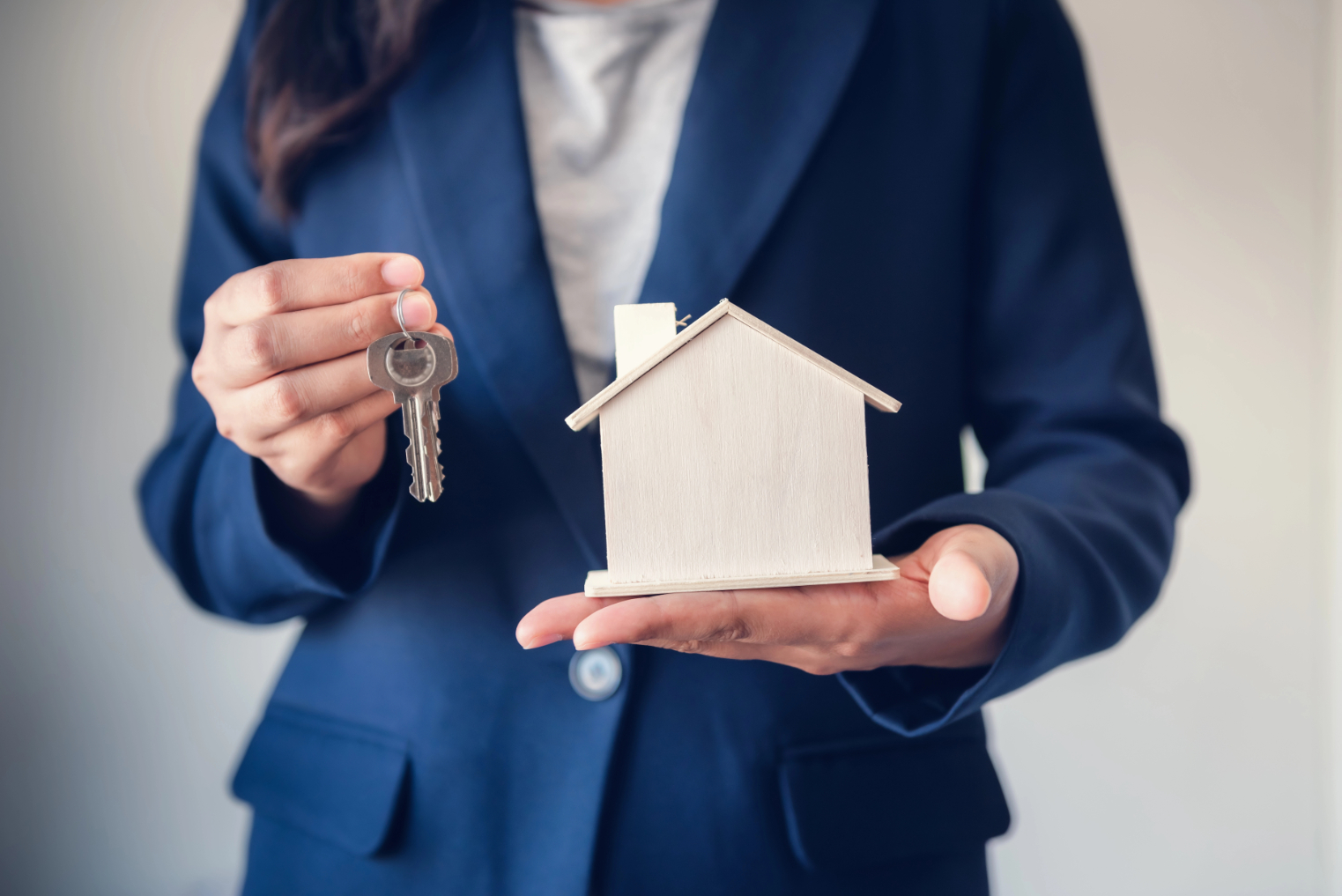Woman Holding House Key and Miniature Woman Holding House Key and Miniature